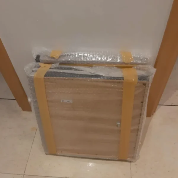 Professional furniture packing in Dubai by MK Movers, featuring items securely wrapped in bubble wrap and cardboard for safe relocation 