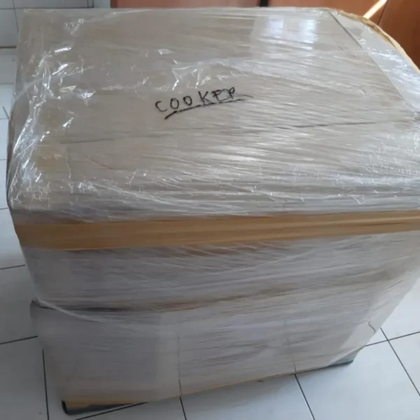 Professional furniture packing in Dubai by MK Movers, showing items securely wrapped in bubble wrap and cardboard for safe relocation 