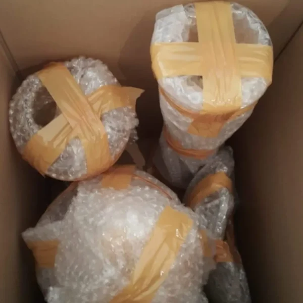 Fragile items wrapped in bubble wrap and tape packed in cardboard box