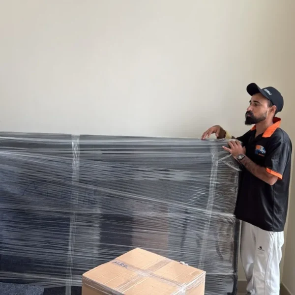 MK Mover and Packer team wrapping furniture with plastic wrap for safe moving